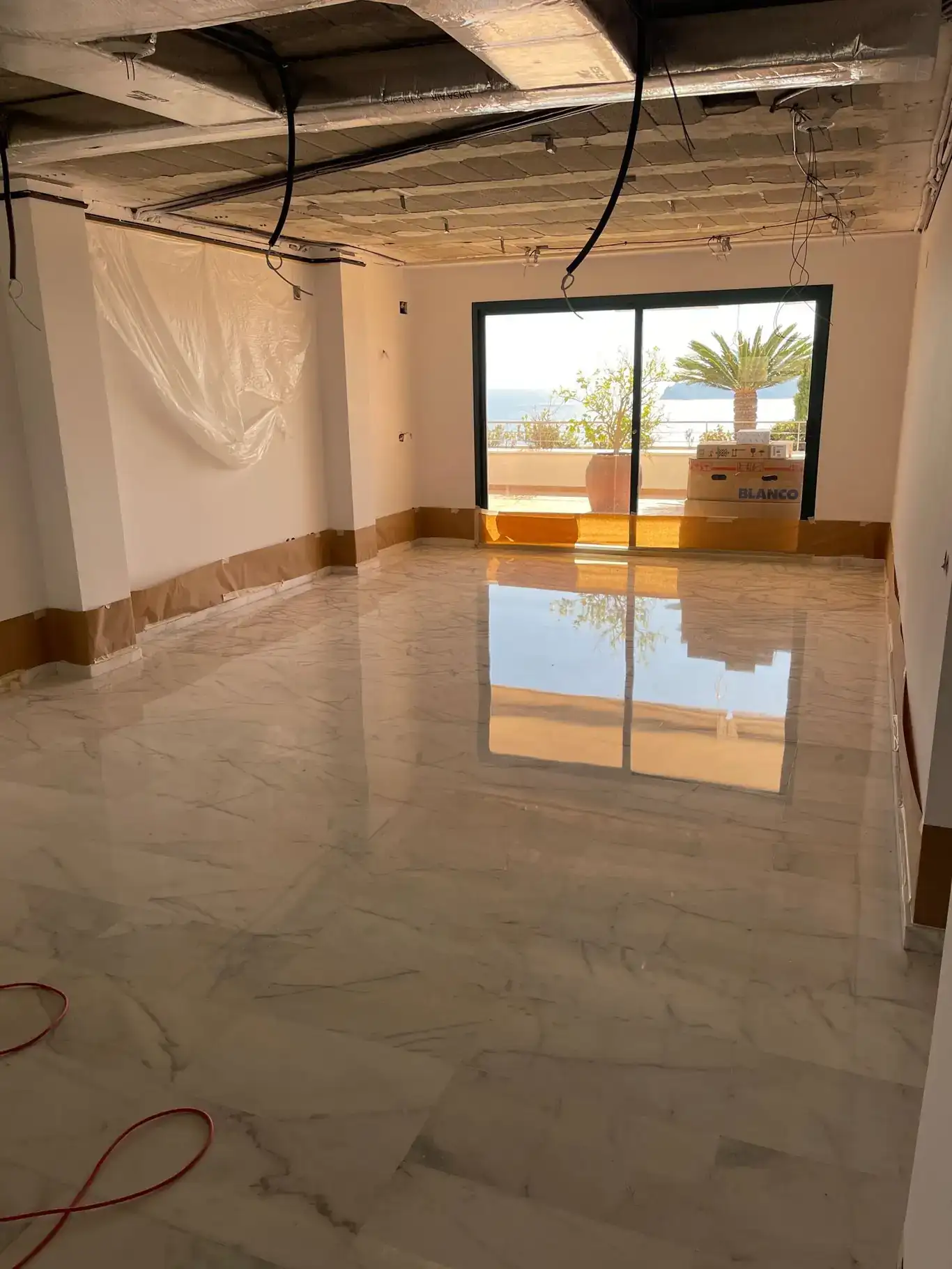 Suelo de mármol blanco tras proceso de pulido después de una reforma