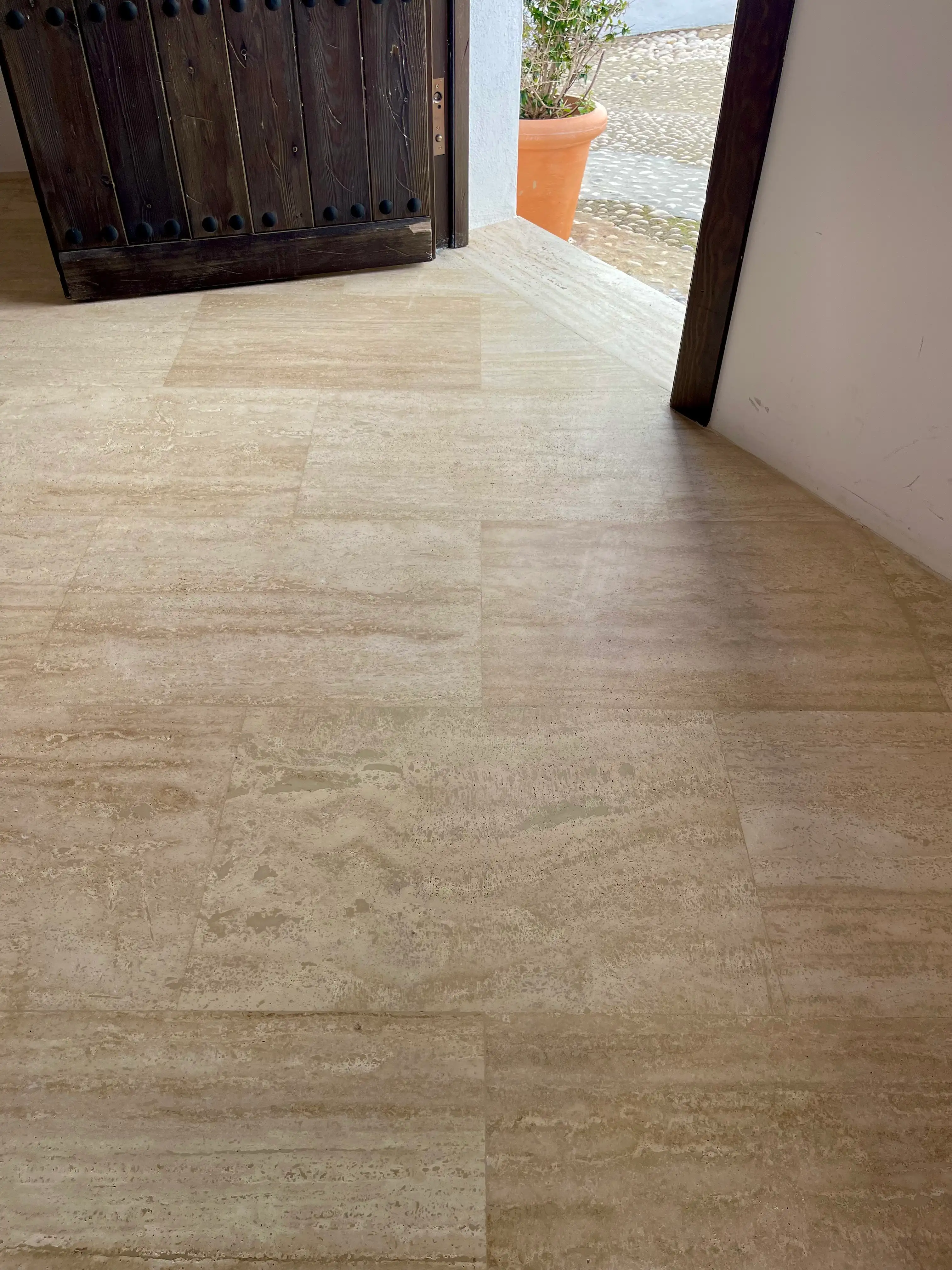 Travertine marble floor with uniform matte finish after polishing and water-repellent treatment in an old house in Altea
